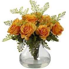 a vase filled with yellow roses and greenery