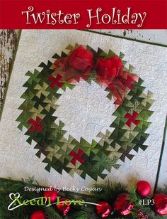 a quilted christmas wreath hanging on the side of a wall