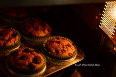 some muffins are sitting on a tray in the oven