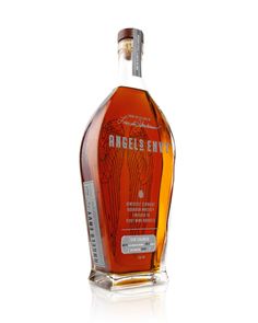 an empty bottle of angel's envy whiskey on a white background with the label removed