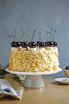 there is a cake with cherries on top