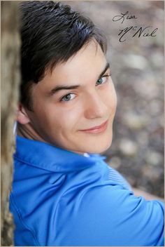 a young man is posing for a photo