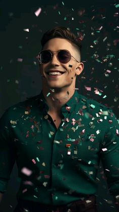 a man wearing sunglasses and confetti falling from his mouth in front of him