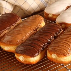 there are many different types of donuts on the cooling rack, including one with chocolate frosting