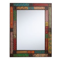 a mirror that is sitting on top of a white surface and has many different colors