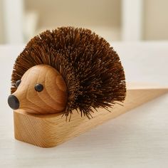 a wooden hedgehog toy sitting on top of a table