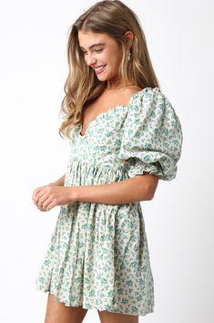 The Lorelei Mini Dress is your go-to for summer, featuring a blue and white floral print. With puff sleeves and ruffle detailing on the hem, neckline, and sleeves, this flowy linen dress exudes effortless elegance. Perfect for sunny days, it keeps you cool and stylish from brunch to beach strolls. Color: Blue Self: 100% Linen, Lining: 100% Rayon Hand wash cold, hang to dry. Item #2402-10LDJ Please call for in-store availability Size/Fit Model is wearing size S. Summer Puff Sleeve V-neck Dress With Ruffle Hem, Spring Floral Dress With Gathered Sleeves For Garden Party, Chic Spring Floral Puff Sleeve Dress, Flowy Puff Sleeve Dress With Square Neck For Spring, Billowy Dress For Spring Garden Party, Spring Billowy Dress For Garden Party, Billowy Spring Garden Party Dress, Cottagecore Summer Puff Sleeve Dress With Gathered Sleeves, Cottagecore Puff Sleeve Dress With Gathered Sleeves For Summer