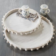 two white plates with blue and white designs on them