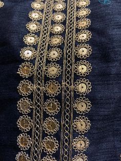 an embroidered piece with gold thread on it