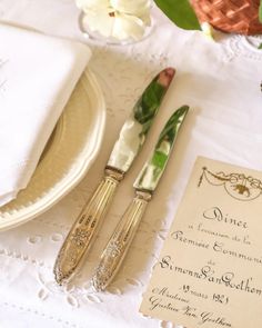 the table is set with silverware and place settings