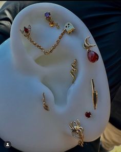 an assortment of jewelry is displayed on a white plate