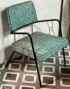 a blue chair sitting on top of a tiled floor