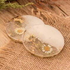 two glass plates sitting on top of a burlock covered table cloth next to a plant