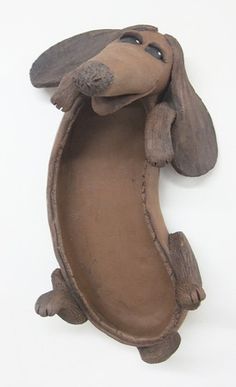 a clay dachshund hanging on the wall