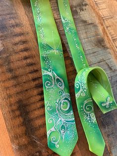 Hand-painted skinny tie in lime-green colorway. Floral art. The men's necktie is very bright and exclusive, can make a favorite accessory for a young gentleman who likes to cheer up his everyday look with silk ties. It is also a great groomsmen gift for a wedding. The men's necktie has a nice touch. Such accessories for men perfectly complements the business suit. The accessory will look great both in the office and at the evening or party event. The model has a stylish coloring. The material is Green Standard Tie For Summer, Green Summer Ties For Gift, Green Summer Ties For Gifts, Green Summer Ties As Gift, Green Summer Ties As Gifts, Green Summer Standard Tie, Green Tie For Spring Gift, Green Ties For Spring Gift, Green Ties As Spring Gifts