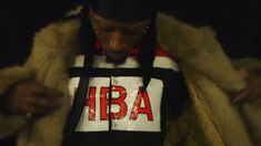 a man in a white and black jacket with the word iba on it