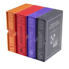 four colored books are stacked on top of each other in the same color book box