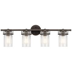 three light bathroom fixture with clear glass jars on the bottom and an antique bronze finish