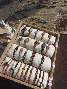 a box filled with lots of bracelets on top of a table