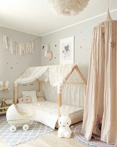 a child's bedroom with a canopy bed and toys