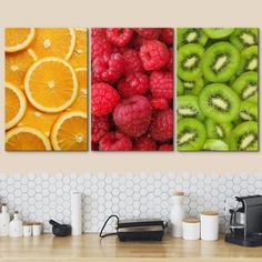 three panels of fruit with oranges, raspberries and kiwi on them