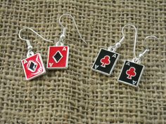 three pairs of earrings with playing cards in red, black and white colors on them