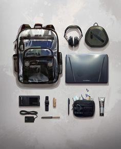 the contents of a backpack laid out on a white surface, including headphones and other items