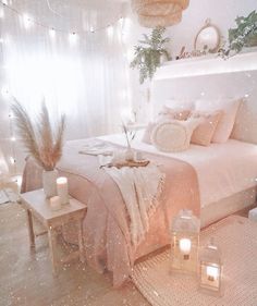 a bedroom with white walls and lots of lights on the ceiling is lit by candles