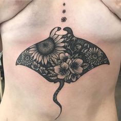 a woman's stomach with a tattoo on it