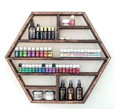 a wooden shelf filled with lots of different types of essential oils and other things on it