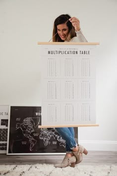 a woman is holding up a table calendar