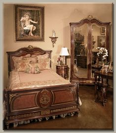 a bed room with a neatly made bed next to a large mirror and two lamps