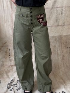 Handmade, one of a kind pants made using a Korean war era US military sleeping bag. Inspired by vintage riding pants, these have a barrel shaped leg silhouette and the option to become tapered at the ankles by adjusting the button strap. Have a double reinforced seat and a small front pocket. I put two 1940s-1950s "Howe Military Academy Riding Camp" felt patches on the front. Lightweight cotton poplin material. Please note there are areas of light staining, discoloration, and small distressed ar Military Style Baggy Parachute Pants With Patch Pockets, Military Style Straight Leg Parachute Pants, Military Style Parachute Pants With Hip Pockets, Khaki Full-length Military Parachute Pants, Military Style Full Length Khaki Parachute Pants, Military Style Full-length Khaki Parachute Pants, Military Style Straight Leg Khaki Parachute Pants, Military Style Straight Leg Parachute Pants In Khaki, Baggy Military Cargo Pants