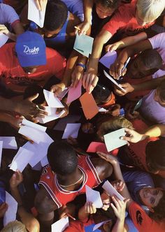 a group of young people standing around each other