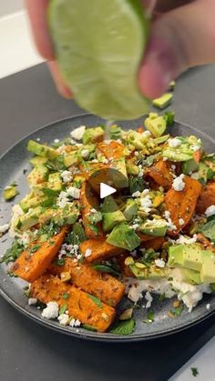 a plate full of food that includes carrots, avocado and feta cheese