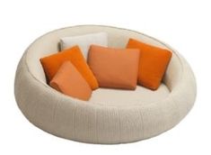 a white and orange couch with four pillows on the bottom one is made out of fabric