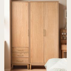 a bedroom with a bed and two wooden cupboards