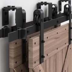 a close up of a wooden door with black hardware and sliding doors on the side