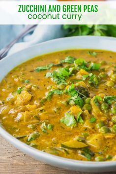 a white bowl filled with green pea soup and garnished with cilantro