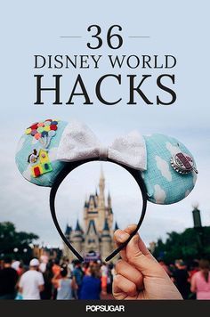 a person holding up a mickey mouse ears headband in front of a castle with the words disney world hacks on it