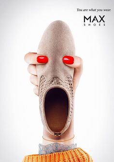 an advertisement for max shoes with a woman's hand holding the shoe in front of her face