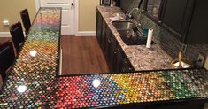 the counter top is made out of many bottle caps