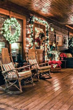 the porch is decked out with rocking chairs and christmas wreaths on the wall