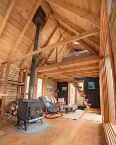 an instagramted photo of a log cabin with wood burning stove in the foreground