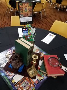 a table topped with books and a magnifying glass sitting on top of it