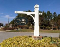 a sign for the cove in front of some bushes