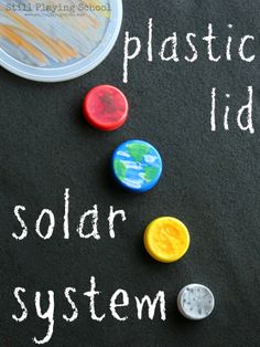 a chalkboard with plastic buttons and the words solar system written on it