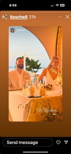 a man and woman sitting at a table in front of an open air gazebo