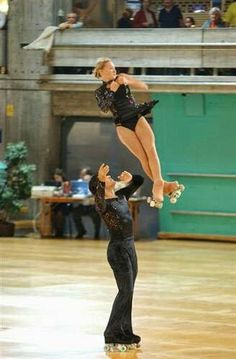 a man and woman are performing an acrobatic dance