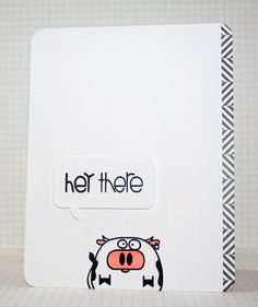 a cow with a speech bubble saying her the e on it's face, sitting in front of a notebook